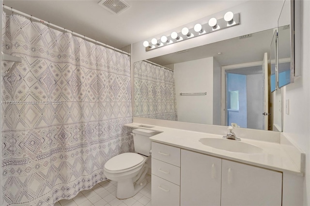 bathroom featuring vanity, tile patterned floors, and toilet