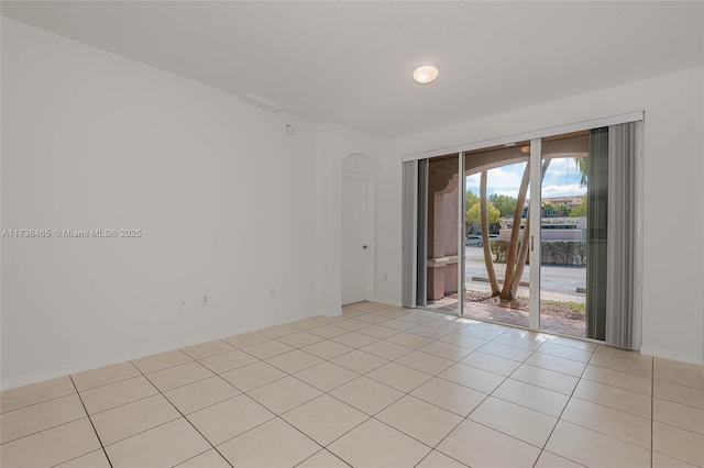 spare room featuring light tile patterned flooring