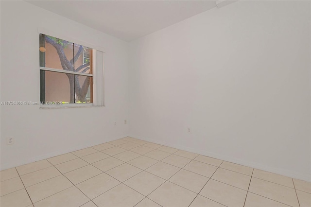 spare room featuring light tile patterned floors