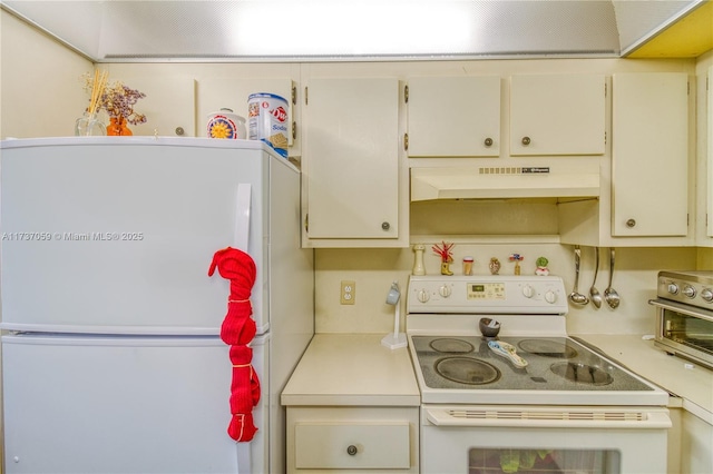 kitchen with white appliances and cream cabinetry