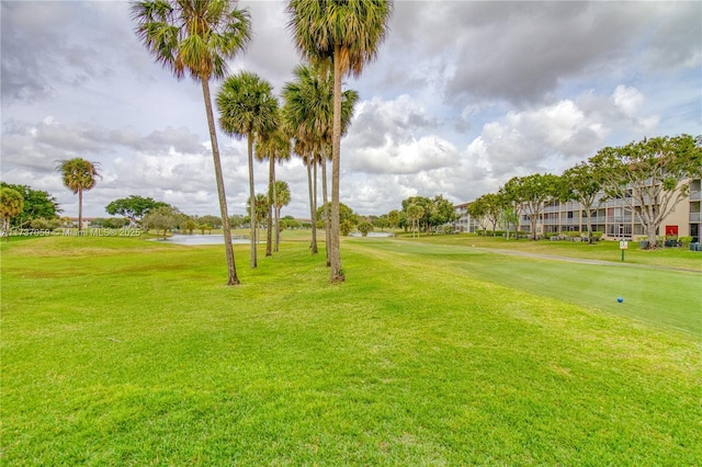 view of community with a water view and a yard