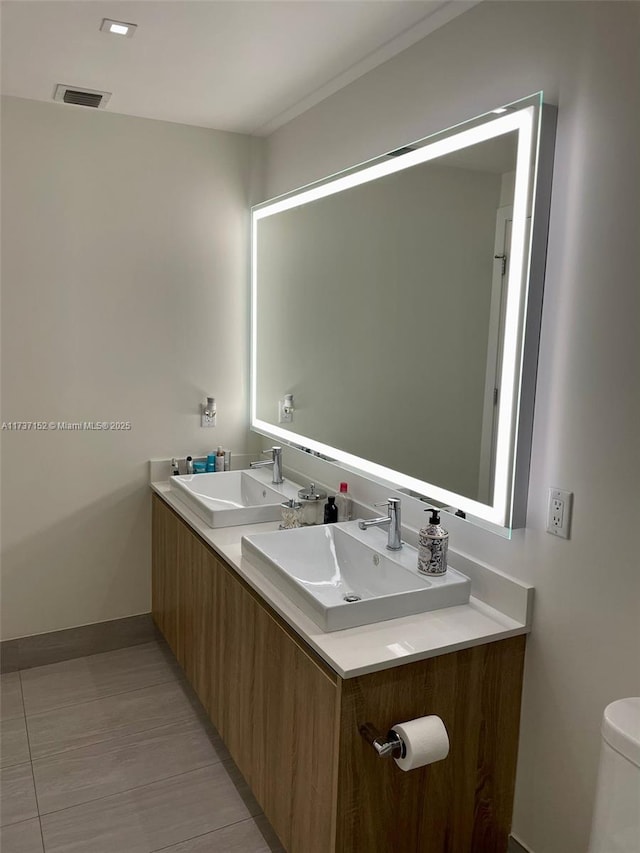 bathroom featuring vanity and toilet