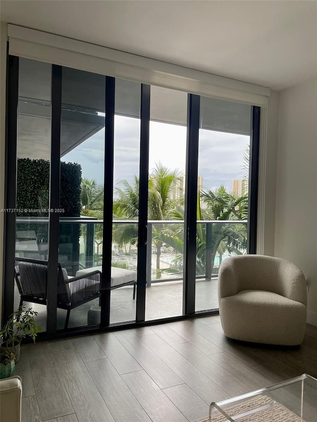 doorway to outside with hardwood / wood-style flooring and a wall of windows