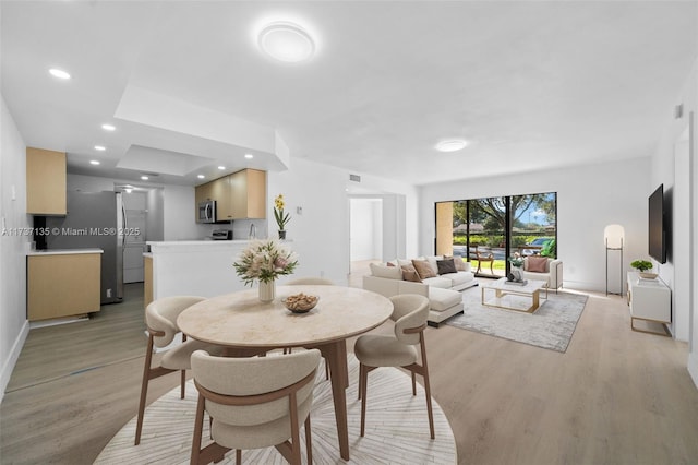 dining space with light wood-type flooring