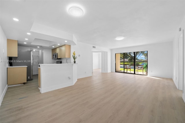 unfurnished living room with light hardwood / wood-style flooring