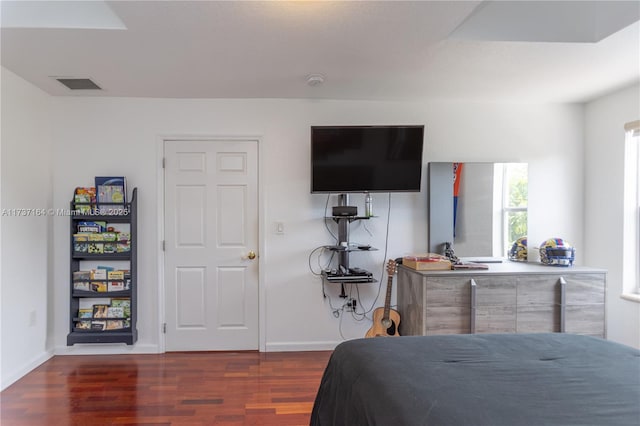 bedroom with dark wood-type flooring