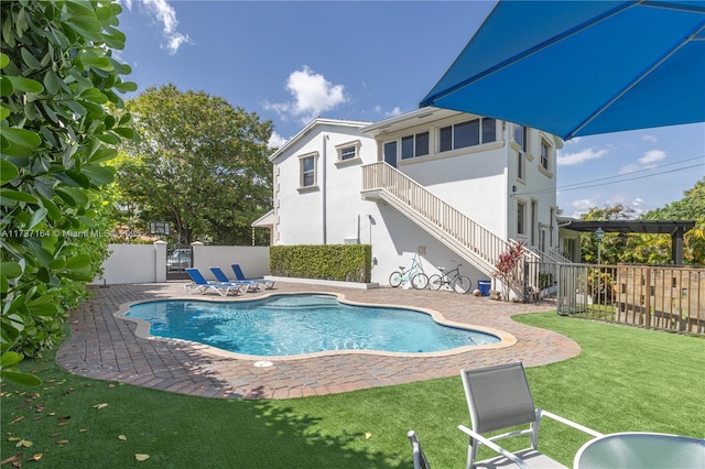 view of swimming pool featuring a yard and a patio