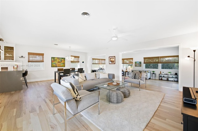 living room featuring ceiling fan and light hardwood / wood-style floors