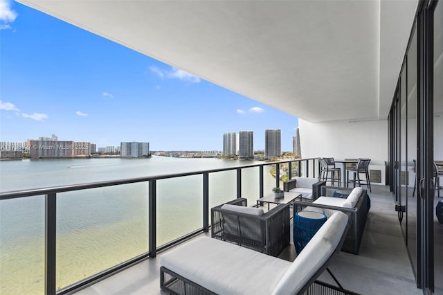 balcony with outdoor lounge area and a water view