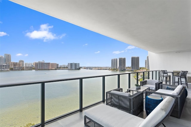 balcony with an outdoor hangout area and a water view