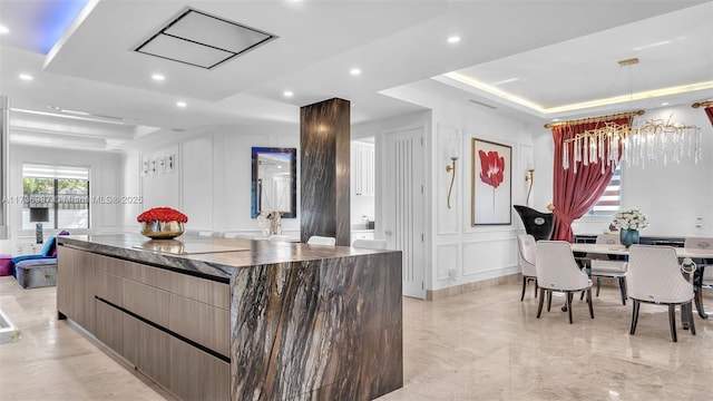 kitchen with a raised ceiling and a kitchen island