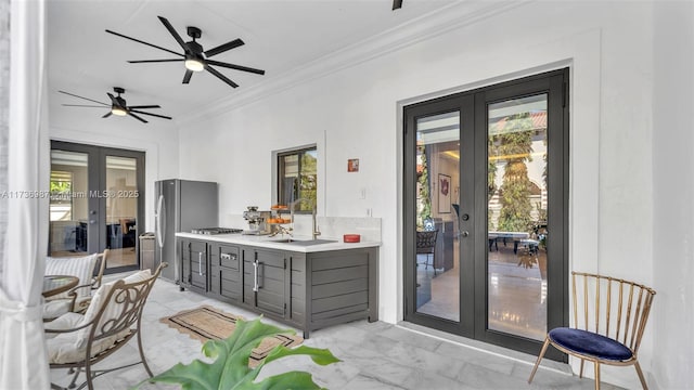 interior space with sink, crown molding, gray cabinets, stainless steel refrigerator, and french doors