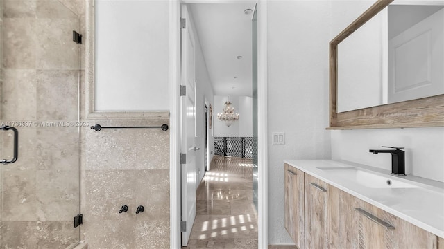 bathroom with vanity and a shower with door