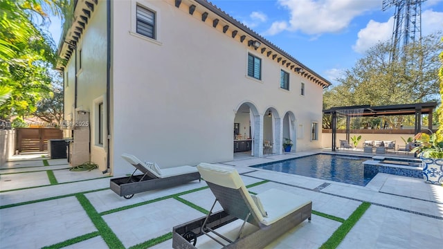 view of pool with an outdoor hangout area, a patio area, and an in ground hot tub