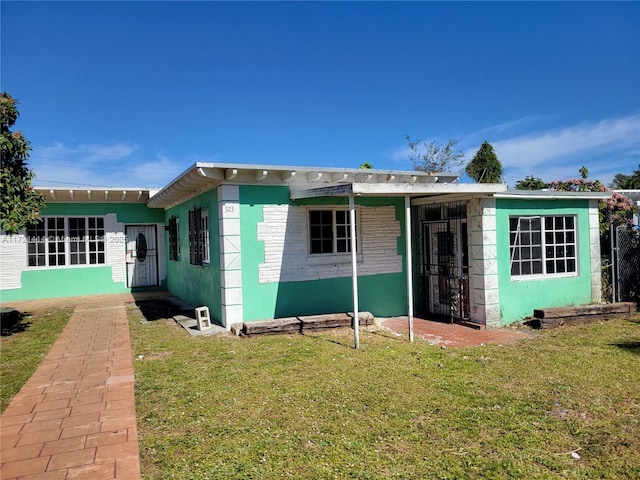 rear view of property with a yard