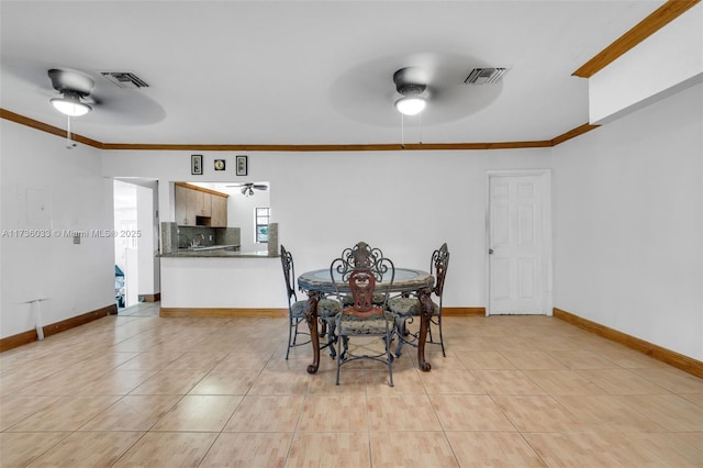 tiled dining room with ornamental molding and ceiling fan