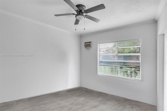 unfurnished room featuring ceiling fan, crown molding, and a textured ceiling