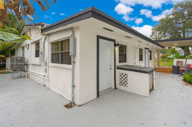 view of side of home with a patio