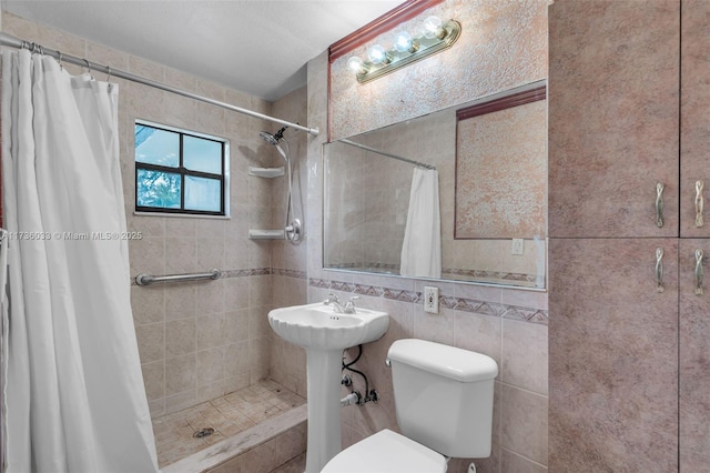 bathroom featuring tile walls, toilet, and walk in shower