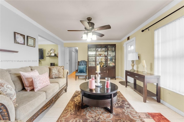 living room with light tile patterned floors, crown molding, and ceiling fan