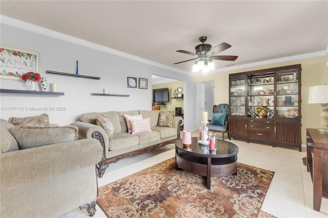 tiled living room with ceiling fan and ornamental molding