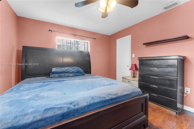 bedroom with dark wood-type flooring and ceiling fan