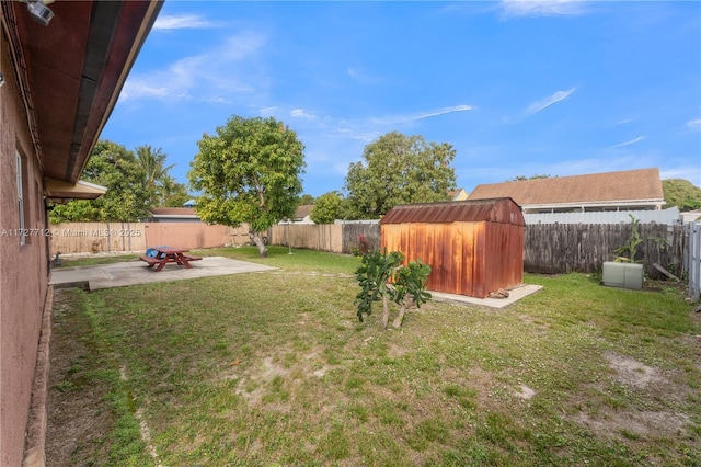 view of yard with a storage shed and a patio area