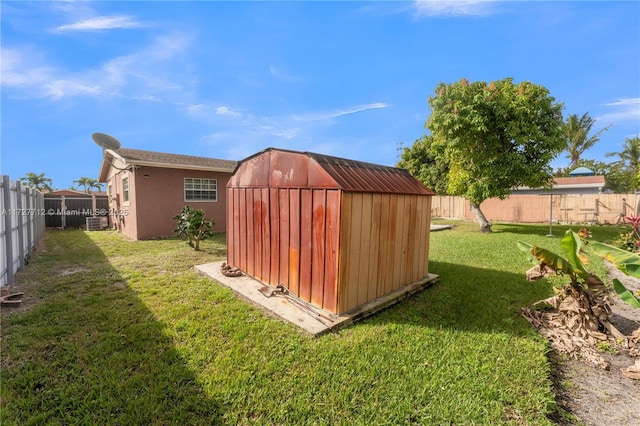 view of outbuilding featuring central AC and a lawn