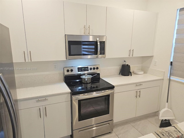 kitchen with stainless steel appliances and white cabinets