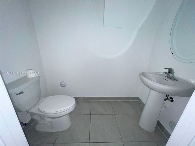 bathroom with tile patterned flooring and toilet