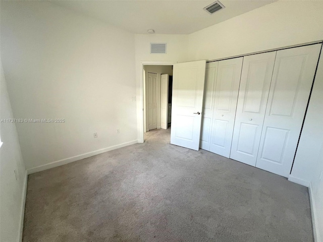 unfurnished bedroom featuring carpet and a closet