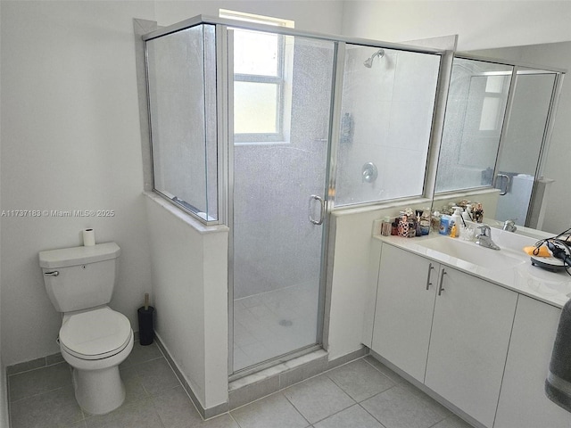 bathroom featuring vanity, walk in shower, tile patterned floors, and toilet