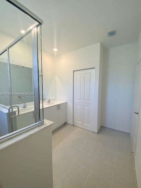 bathroom with vanity and tile patterned flooring