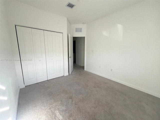 unfurnished bedroom featuring carpet floors and a closet