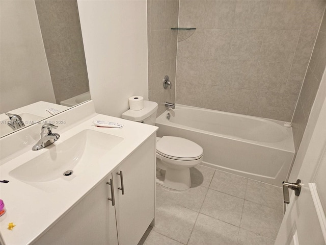 full bathroom with tiled shower / bath combo, vanity, tile patterned floors, and toilet