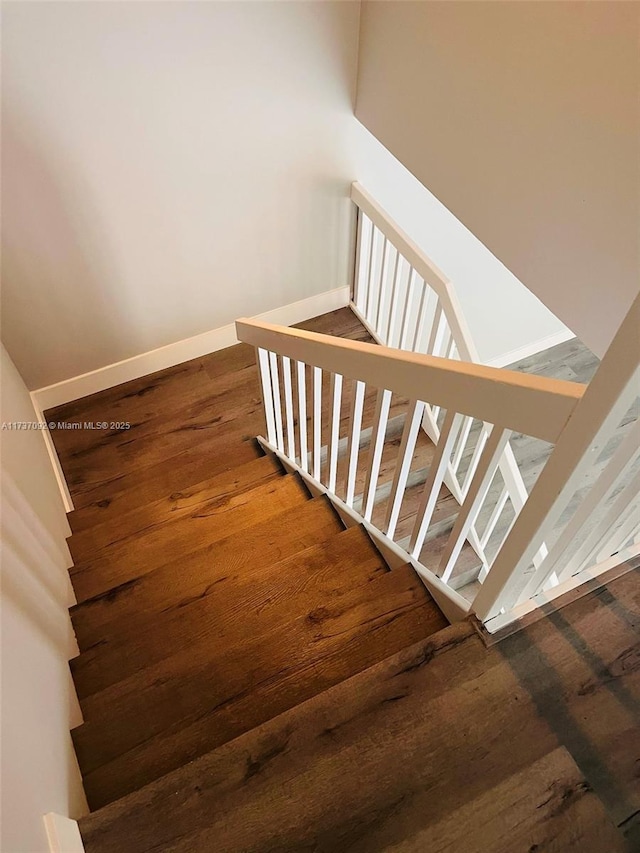 stairs with hardwood / wood-style floors