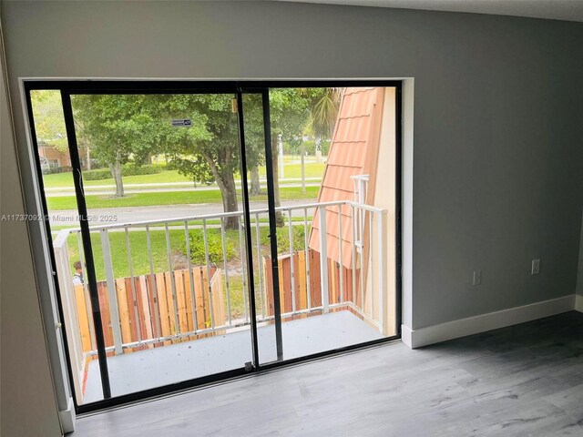 529 Green Springs Pl, West Palm Beach, FL 33409 - doorway to outside featuring wood finished floors and baseboards