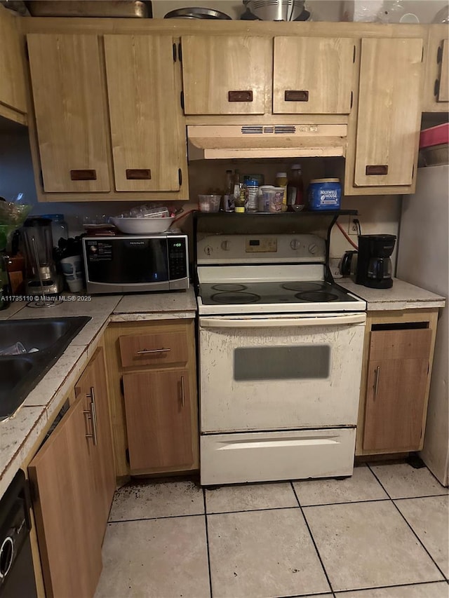 kitchen featuring electric stove, light tile patterned floors, sink, and dishwasher