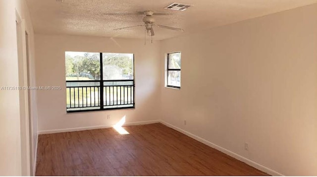 spare room with hardwood / wood-style flooring, ceiling fan, and a textured ceiling