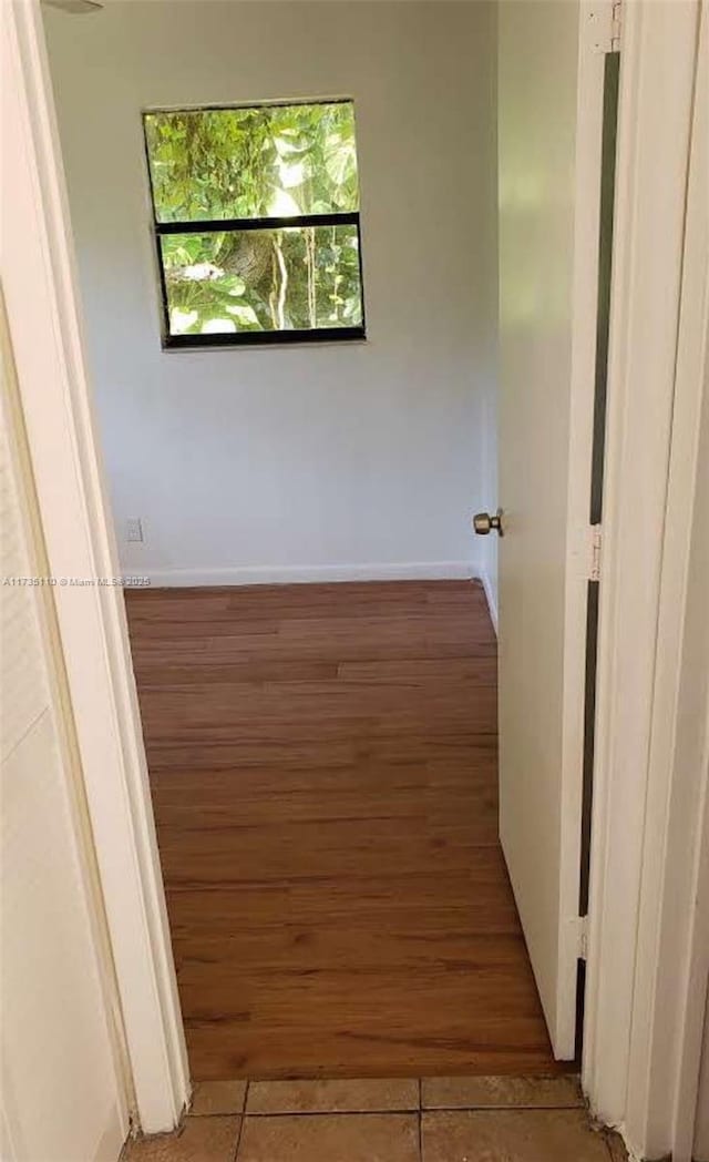 hall with dark wood-type flooring