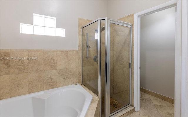 bathroom with tile patterned flooring and separate shower and tub