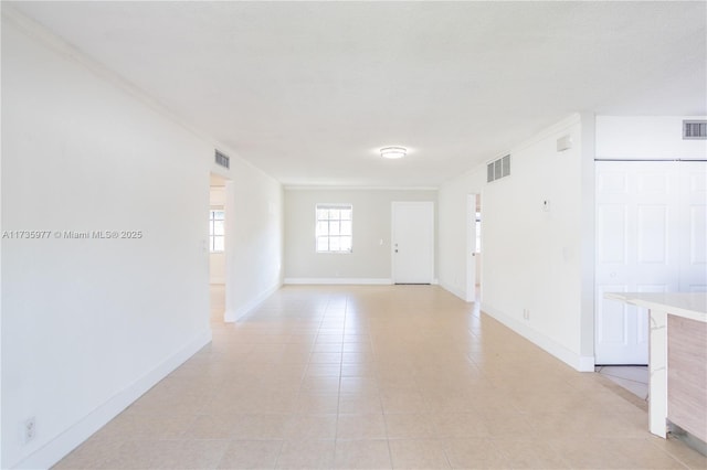 empty room featuring crown molding