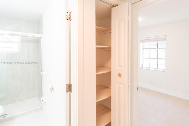 bathroom featuring a shower with door