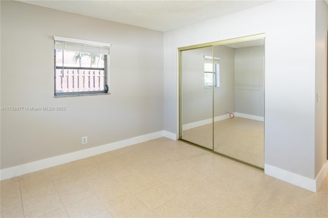 unfurnished bedroom featuring a closet and a textured ceiling