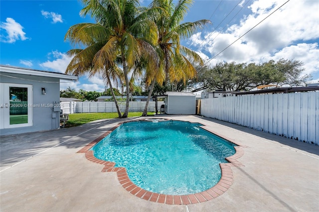 view of pool featuring a patio area and a storage unit