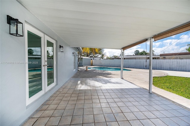 view of patio featuring a fenced in pool and french doors