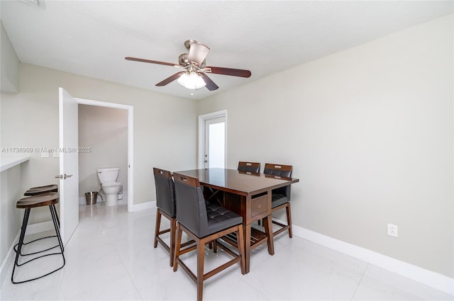 dining area with a textured ceiling and ceiling fan