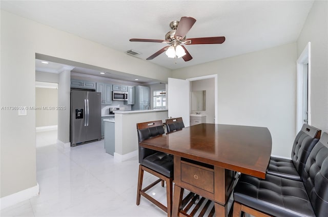 dining room featuring crown molding and ceiling fan