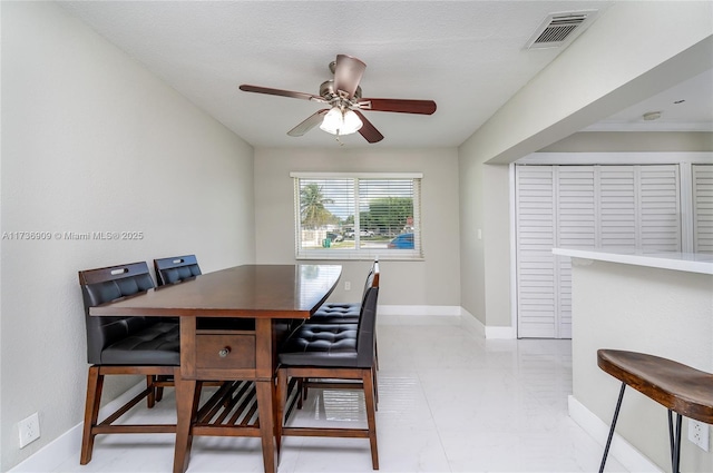 dining space with ceiling fan