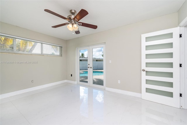 spare room featuring french doors and ceiling fan